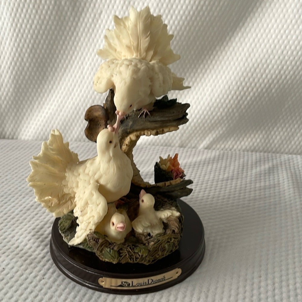 Louis Dionne Doves Figurine featuring a family of four white doves.